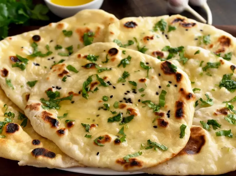 A Guide to 10 Essential Indian Breads: From Naan to Appam